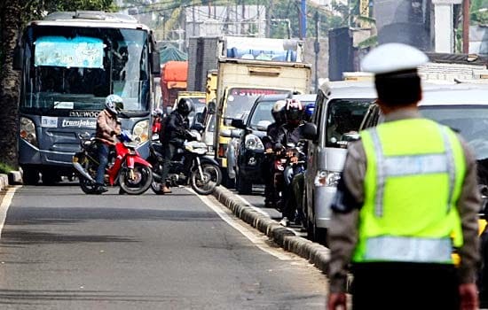 Seorang polisi mendatangi pengendara yang melanggar aturan lalu lintas