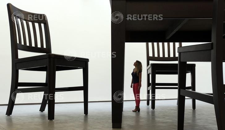 A visitor looks at a monumental sculpture by artist Robert Therrien in the newly opened Metropolitan Arts Centre in Belfast